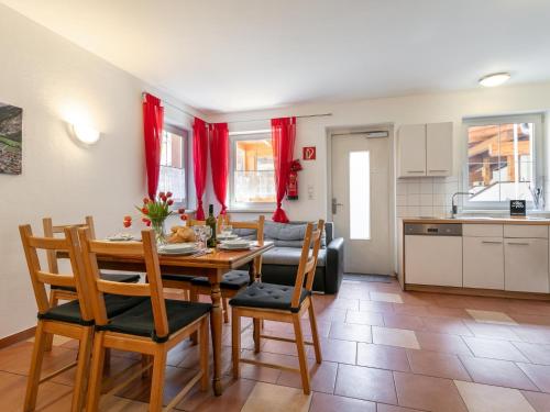 a kitchen and dining room with a table and chairs at Haus Oliver 1 in Winkle
