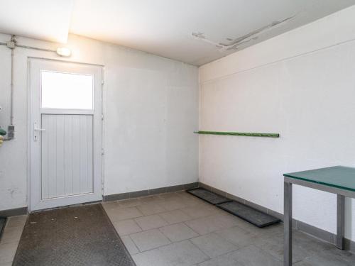 an empty room with a door and a green table at Haus Joachim in Winkle