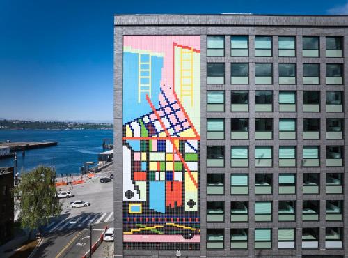 a mural on the side of a building at citizenM Seattle Pioneer Square in Seattle