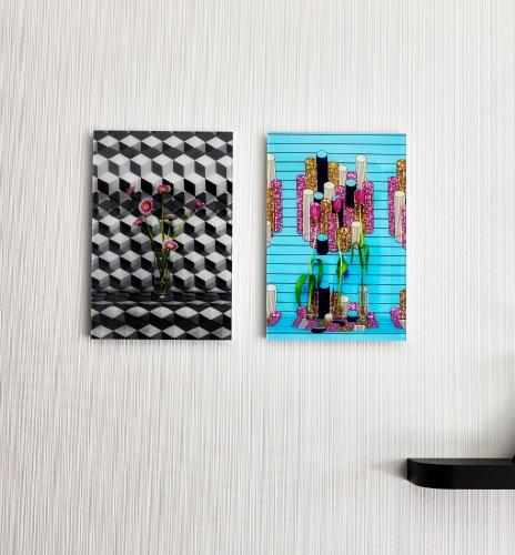 two pictures hanging on a wall with a vase of flowers at citizenM Seattle Pioneer Square in Seattle