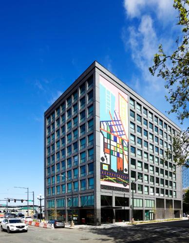 a building with a large mural on the side of it at citizenM Seattle Pioneer Square in Seattle