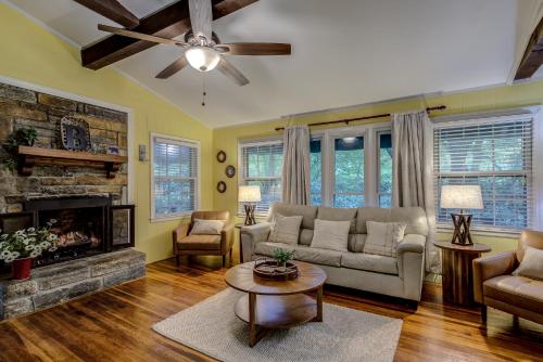 a living room with a couch and a fireplace at Mountain Home near Blue Ridge Parkway, Central Location! in Blowing Rock