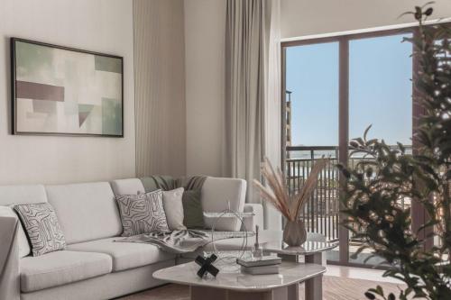 a living room with a couch and a table at F1 Yas Luxury 1BR Golf&Water View w tkt discount in Abu Dhabi