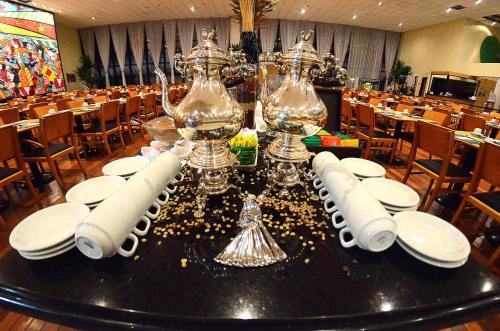 a dining room with a table with plates and glasses at Holiday Inn Sao Paulo Parque Anhembi by IHG in Sao Paulo