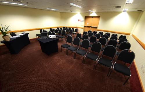 a conference room with chairs and a podium in it at Holiday Inn Sao Paulo Parque Anhembi by IHG in Sao Paulo