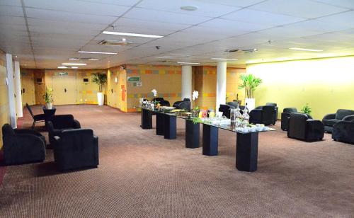 a conference room with tables and chairs in a building at Holiday Inn Sao Paulo Parque Anhembi by IHG in Sao Paulo