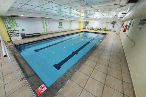 a large indoor swimming pool in a building at Holiday Inn Sao Paulo Parque Anhembi by IHG in Sao Paulo