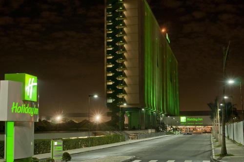 a building with green lights on it at night at Holiday Inn Sao Paulo Parque Anhembi by IHG in Sao Paulo