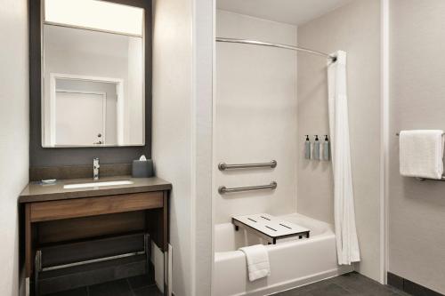 a bathroom with a sink and a shower at Courtyard Minneapolis St. Paul/Roseville in Roseville