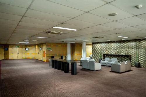 a large room with chairs and tables in a building at Holiday Inn Sao Paulo Parque Anhembi by IHG in Sao Paulo
