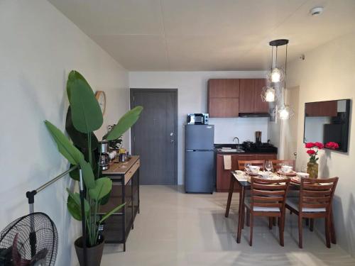 a kitchen and dining room with a table and chairs at Camella Manors Verdant Condo at Puerto Princesa for Family and Couples in Puerto Princesa City