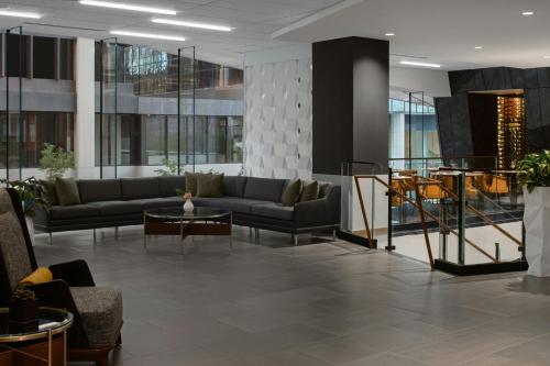 a lobby with a couch and tables in a building at Courtyard by Marriott Calgary Downtown in Calgary