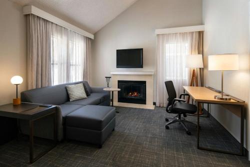 a living room with a couch and a fireplace at Residence Inn Anaheim Placentia/Fullerton in Placentia