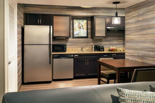 a kitchen with stainless steel appliances and a table at Residence Inn Anaheim Placentia/Fullerton in Placentia