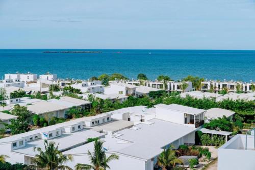 an aerial view of white buildings and the ocean at Izzys in Zanzibar City