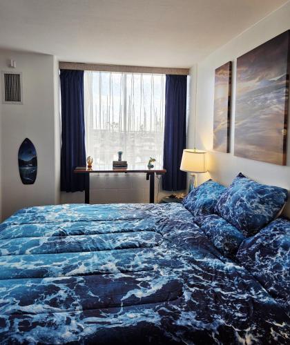 a bedroom with a large bed and a window at Ocean & Marina View Suite in Honolulu