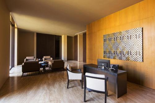 a lobby with chairs and a desk and a painting at JW Marriott Los Cabos Beach Resort & Spa in San José del Cabo