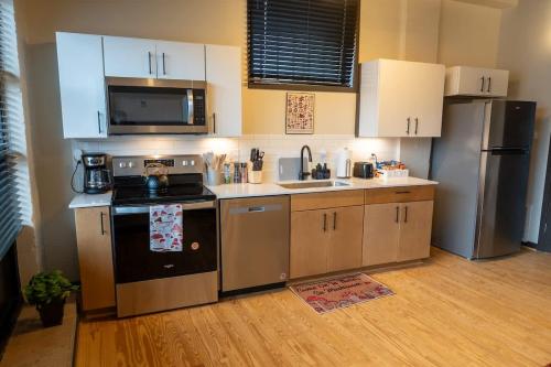 a kitchen with a stove and a refrigerator at Uptown 1BR Apartment Walkable Fayette 102 in Martinsville