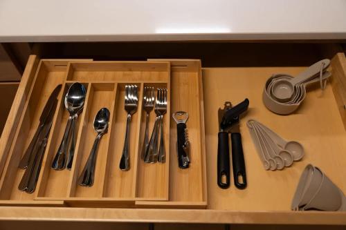 a wooden drawer with utensils in a kitchen at Uptown 1BR Apartment Walkable Fayette 102 in Martinsville