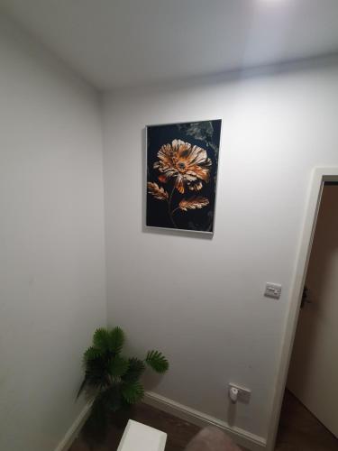 a painting of a flower on a wall at AMH Hotel - Greenford Station in Northolt