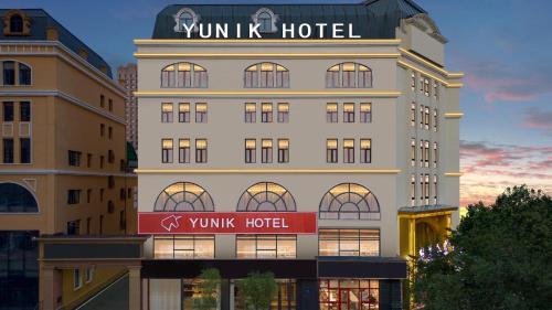 a hotel with a sign on the side of a building at YUNlK Hotel in Harbin
