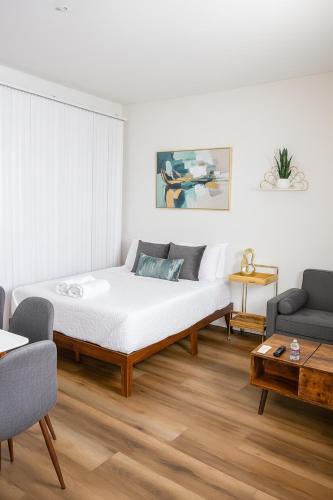 a white room with a bed and a couch at Ocean Breeze Marina Suites with Pool, Gym & Hot Tub in Los Angeles