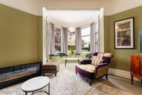 a living room with a chair and a table at The Homestead at Milburn in Milton