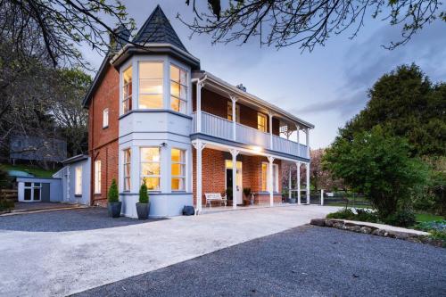 a large brick house with a turret at The Homestead at Milburn in Milton