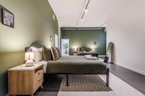 a bedroom with a large bed and a couch at Downtown Escape - 2BR w Skyline Views & Hot Tub in Los Angeles