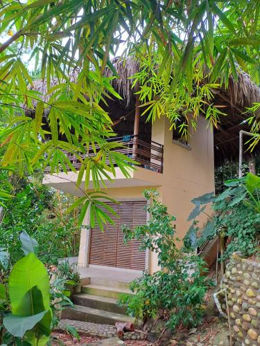 a house with stairs leading up to it at Magdalena Beach House in Los Naranjos
