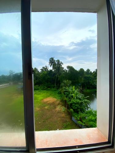 a view of a river from a window at Lakeview Nest in kolkata