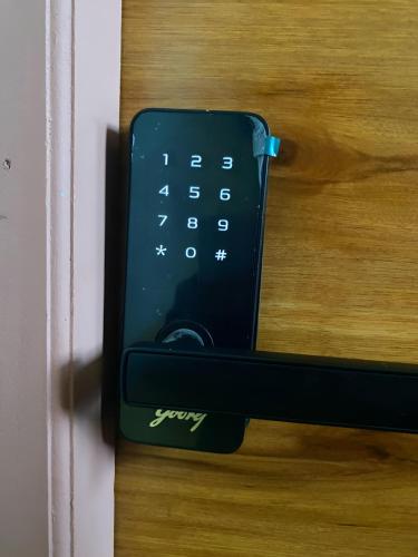 a remote control sitting on top of a door at Lakeview Nest in kolkata