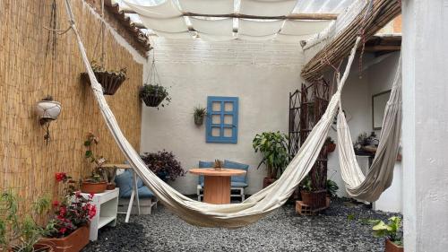 a hammock in the courtyard of a house at Taida Chalet, Ideal for couples near the Center in Villa de Leyva