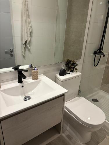 a bathroom with a white sink and a toilet at Pucon Infinity Camino al Volcán in Pucón