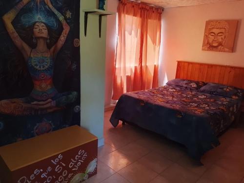 a bedroom with a bed and a painting on the wall at Playa Zen Rodadero in Rodadero