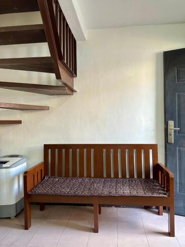a wooden bench sitting in the corner of a room at 2 StoryHome in Tanza near SM along Main Road in Tanza