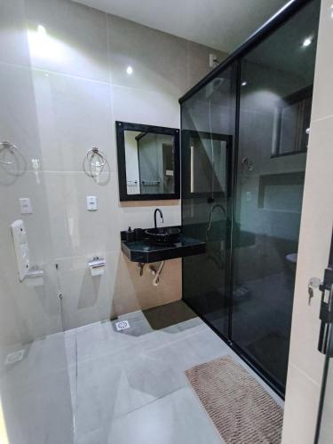 a bathroom with a shower and a sink at Amoras flat in Sao Jorge