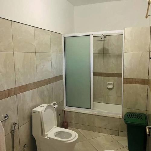 a bathroom with a toilet and a glass shower at Casa Bilene in Macia