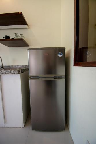 a stainless steel refrigerator in a kitchen next to a counter at Babosam Apartments in Boracay