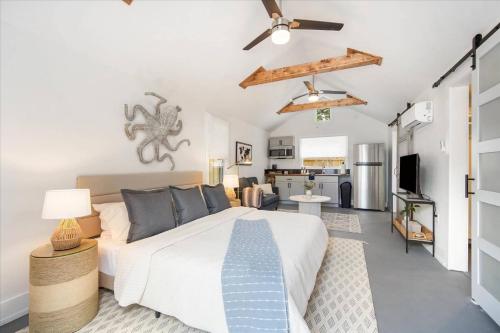 a bedroom with a bed and a living room at Luxe King Studio near Anna Maria Island with Private Parking and Beach Gear and WIFI in Bradenton