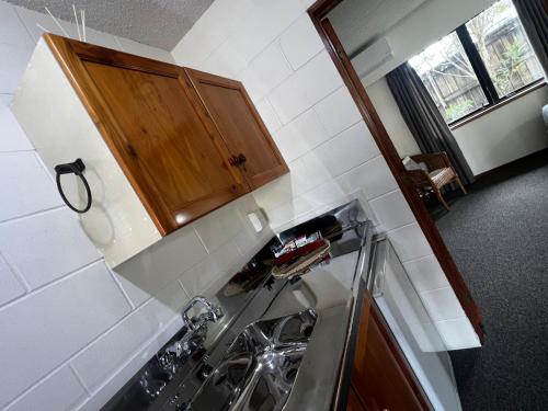 a kitchen with a sink and a counter at Kerikeri Court Motel in Kerikeri