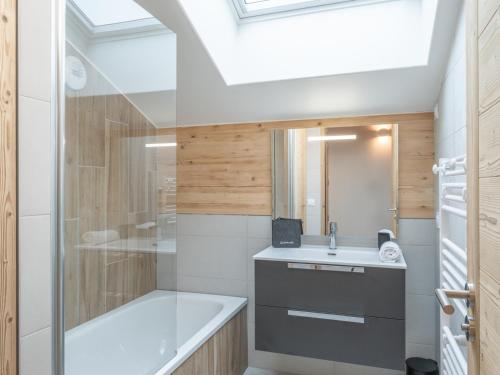 a bathroom with a tub and a sink and a shower at Appartement neuf 4 ch retour ski, garage, 8 pers. - FR-1-645-93 in L'Alpe-d'Huez
