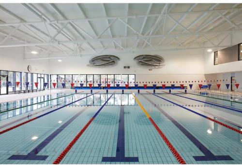 a large swimming pool with lanes in it at Stylish Townhouse in Kensington in Melbourne