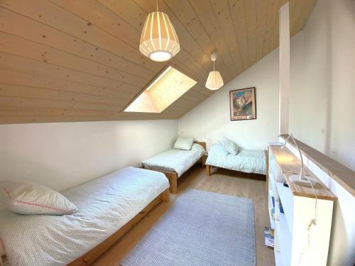 a dorm room with two beds and a window at Bel appartement à Méribel, balcon, 3 min. télésiège et commerces - FR-1-411-997 in Mussillon