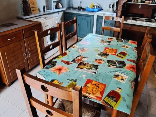 a kitchen with a table with a table cloth on it at Chambre authentique créole aux Avirons - FR-1-786-69 in Ravine Sèche