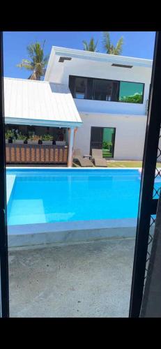 a swimming pool in front of a house at Jasmin Czechinn in Dauis