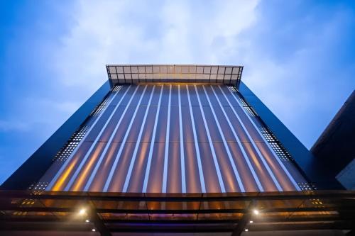 a tall building with lights on the side of it at Blue Moon Alleppey in Alleppey