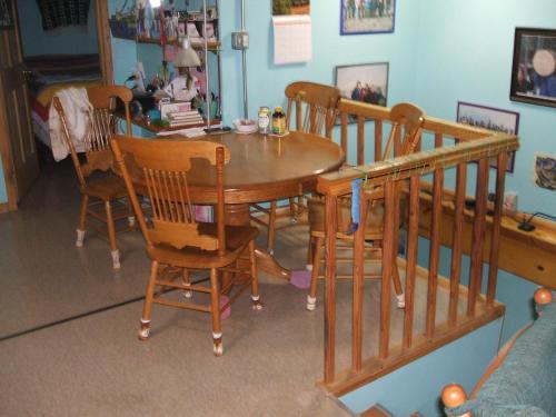 a dining room with a wooden table and chairs at Cook's Place in Tok