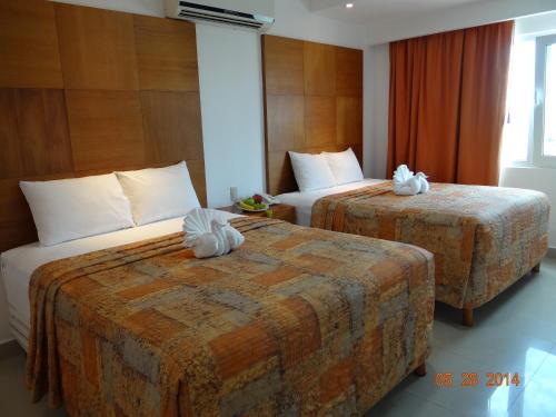 Postel nebo postele na pokoji v ubytování Suites Gaby Cancun