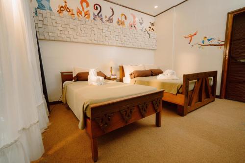 Ένα ή περισσότερα κρεβάτια σε δωμάτιο στο Antonio's Bed and Breakfast Hotel